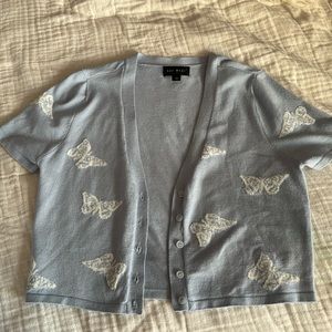 Blue sweater with white butterflies